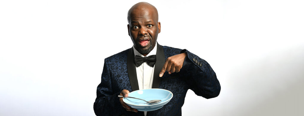 Daliso Chaponda pointing at a blue bowl