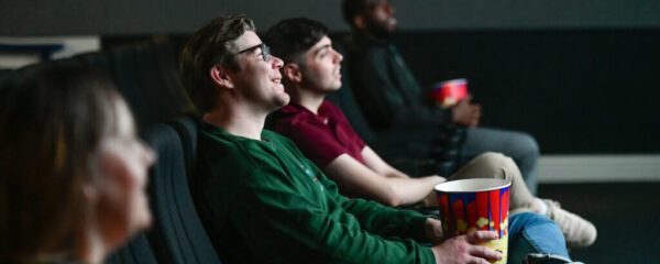 Social Cine-Club. People sat in cinema watching a film