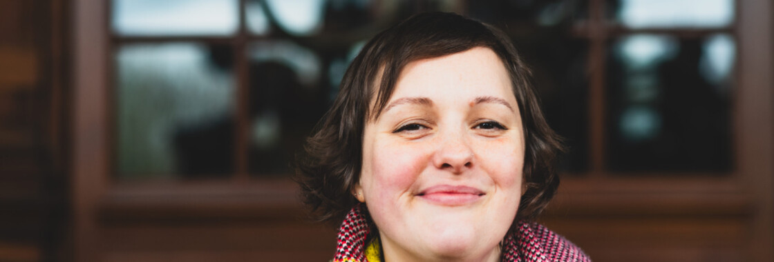 Comedian Josie Long smiling at camera