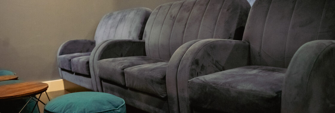 Image of Screen 3, blue soft chairs with green foot stools.