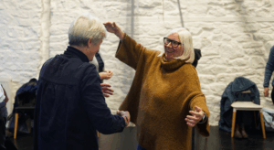 Older People dance and embrace one another joyfully