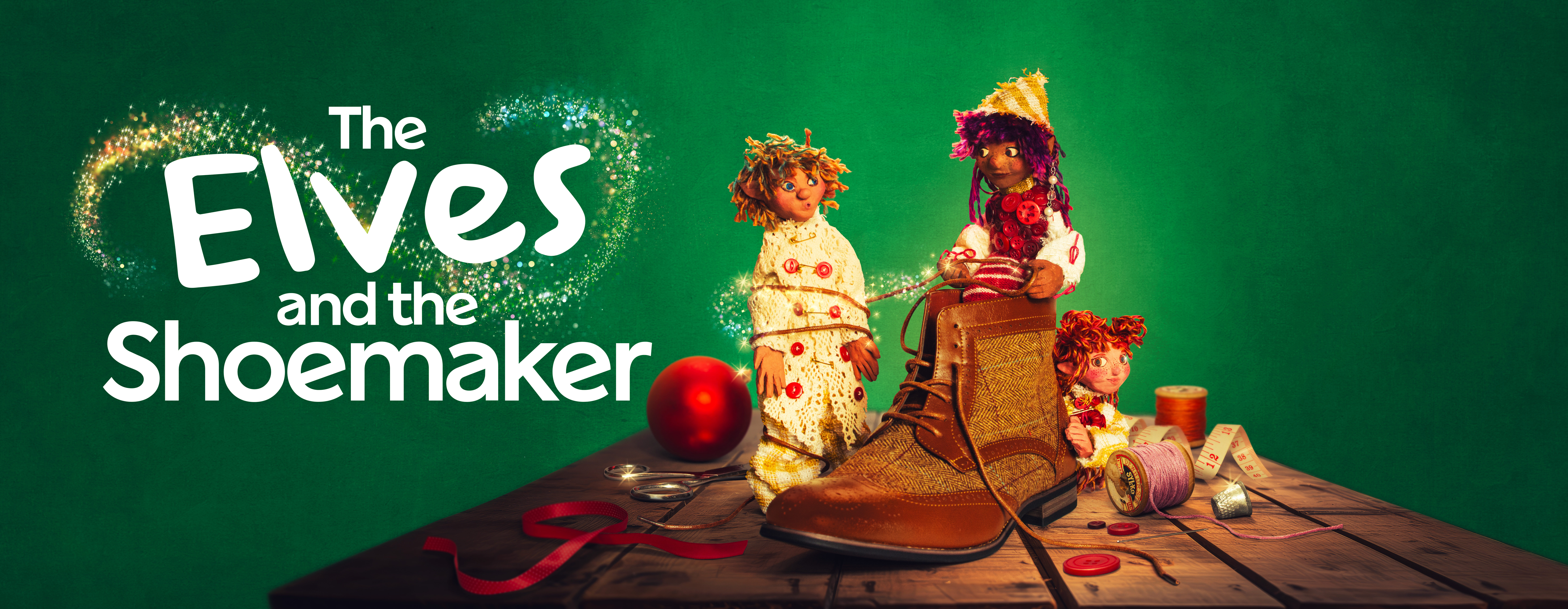3 elves sit on a bench with a shoe, a bauble and ribbon with the words The Elves & The Shoemaker to the left